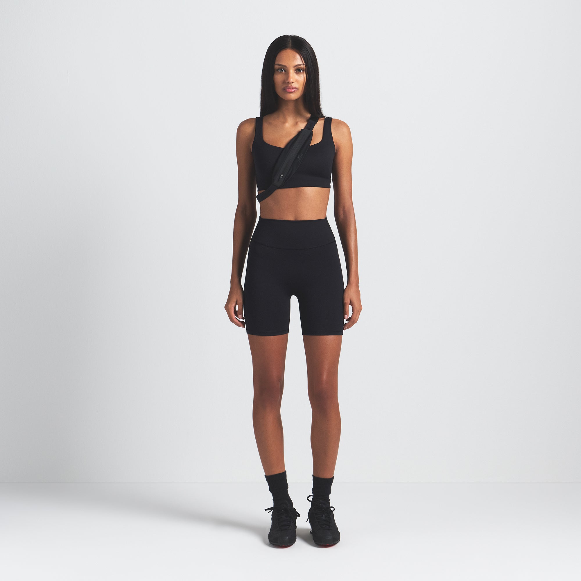 NikeSKIMS MATTE 5" BIKER SHORT | OBSIDIAN ON A MODEL FRONT VIEW @ | FOCUS: 0.9, 0.1, 0.7
