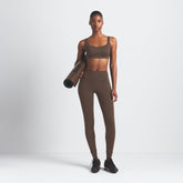 NikeSKIMS MATTE V-LINE 26" LEGGING | DARK SEPIA ON A MODEL FRONT VIEW @ | FOCUS: 0.9, 0.1, 0.7