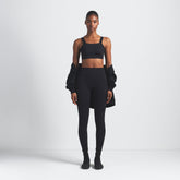 NikeSKIMS MATTE 29" LEGGING | OBSIDIAN ON A MODEL FRONT VIEW @ | FOCUS: 0.9, 0.1, 0.7