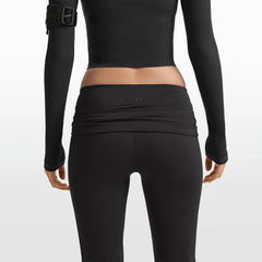 NikeSKIMS MATTE FOLDOVER SLIM FLARE LEGGING | OBSIDIAN ON A MODEL FRONT VIEW @ | FOCUS: 0.0, 1.0, 0.9
