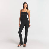 SKIMS BODY HIGH-WAISTED FLARE PANT | ONYX ON A MODEL FRONT VIEW @