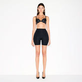 SKIMS BODY BUTT AND HIP ENHANCING MID THIGH SHORT | ONYX ON A MODEL FRONT VIEW @ | FOCUS: 0.0, 1.0, 0.9