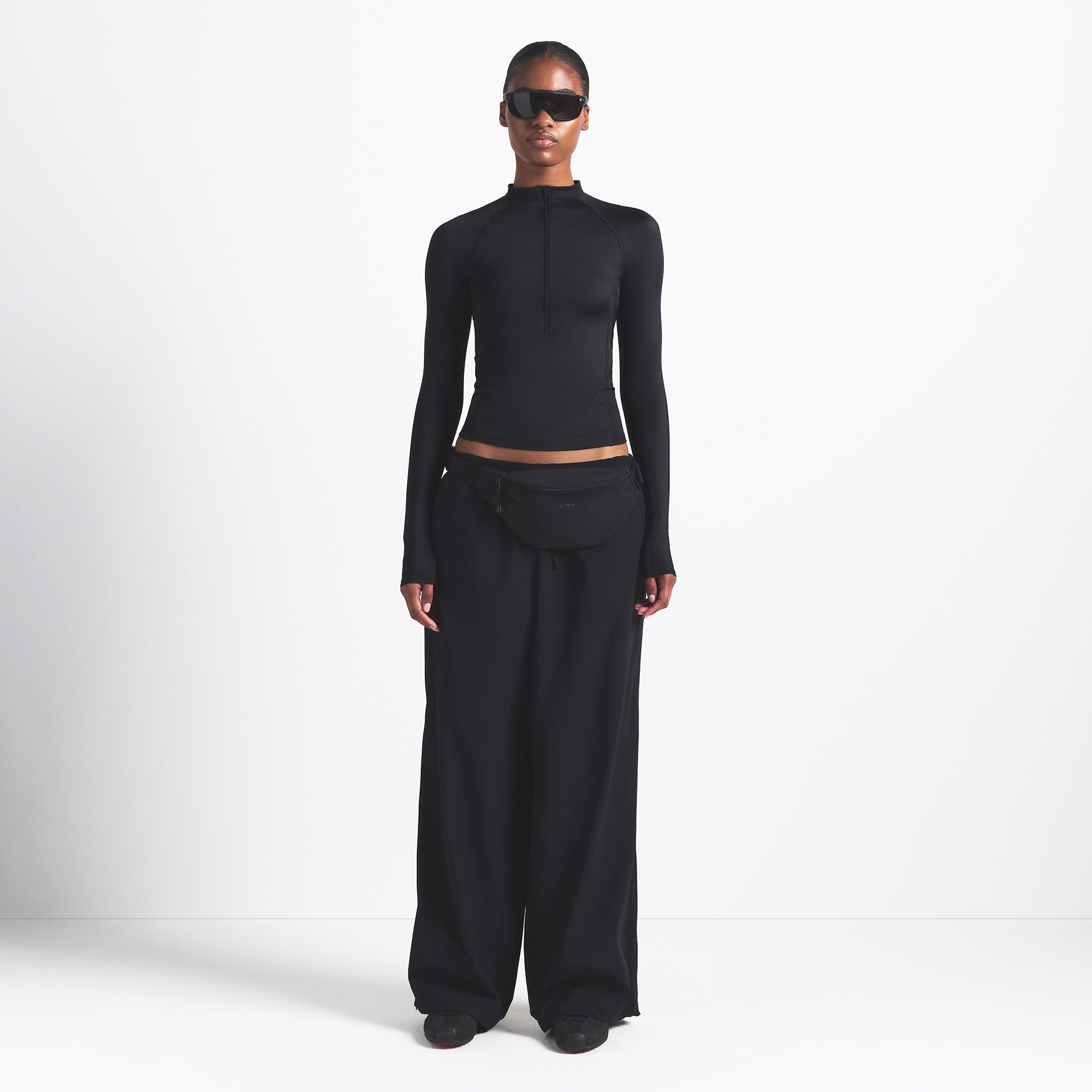 NikeSKIMS WOVEN NYLON OVERSIZED TRACK PANT | OBSIDIAN ON A MODEL FRONT VIEW @ | FOCUS: 0.0, 1.0, 0.9