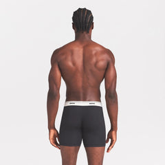 SKIMS COTTON RIB MENS 5" BOXER BRIEF | ONYX ON A MODEL SIDE VIEW @ | FOCUS: 0.0, 1.0, 0.9