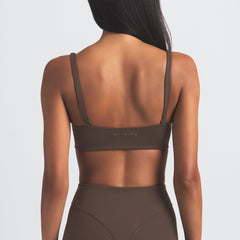NikeSKIMS MATTE MICRO SCOOP BRA | DARK SEPIA ON A MODEL BACK VIEW
