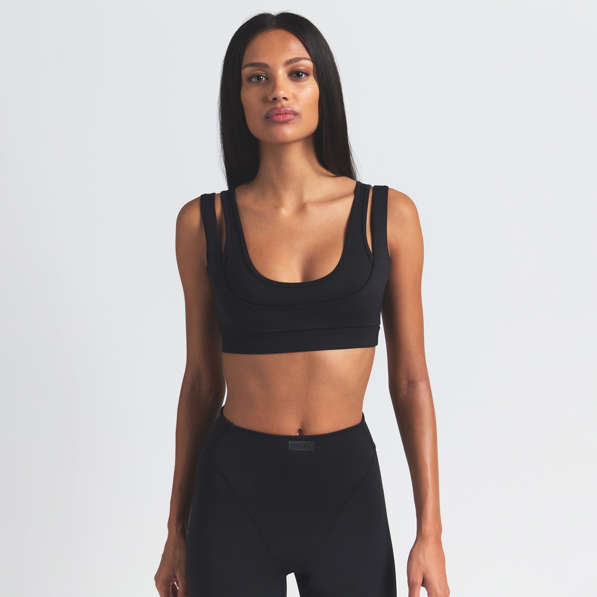 NikeSKIMS MATTE DOUBLE STRAP SCOOP BRA | OBSIDIAN ON A MODEL FRONT VIEW @ | FOCUS: 0.9, 0.1, 0.7
