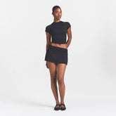 NikeSKIMS AIRY FOLDOVER SKORT | NSKM OBSIDIAN ON A MODEL