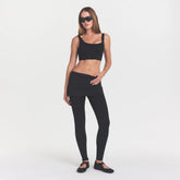 NikeSKIMS MATTE CORSET LONGLINE BRA | OBSIDIAN ON A MODEL