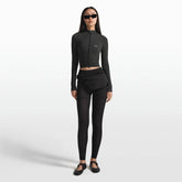 NikeSKIMS ACCESSORIES FANNY PACK | OBSIDIAN ON A MODEL FRONT VIEW @ | FOCUS: 0.0, 1.0, 0.9