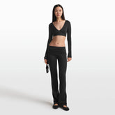 NikeSKIMS MATTE WRAP LONG SLEEVE CROPPED TOP | OBSIDIAN ON A MODEL FRONT VIEW @ | FOCUS: 0.0, 1.0, 0.9