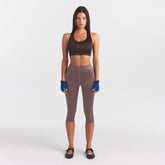 NikeSKIMS SATIN SHINE CAPRI 17" LEGGING | RESIN ON A MODEL FRONT VIEW
