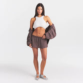 NikeSKIMS STRETCH NYLON SKORT | RESIN ON A MODEL FRONT VIEW @ | FOCUS: 0.0, 1.0, 0.9