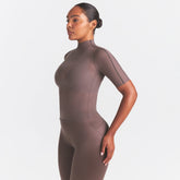 NikeSKIMS WEIGHTLESS LAYERS MOCK NECK SHORT SLEEVE T-SHIRT | RESIN ON A MODEL SIDE VIEW @ | FOCUS: 0.0, 1.0, 0.9