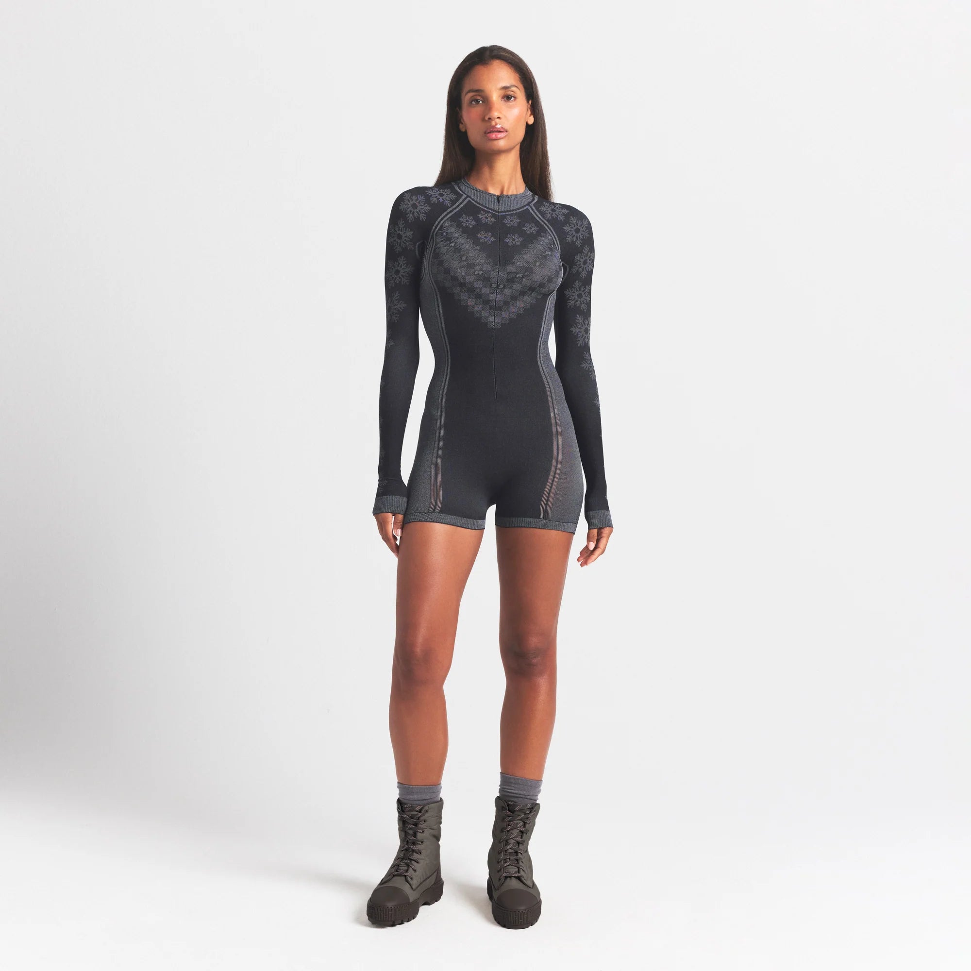 SKIMS FIRST LAYERS HALF ZIP ONESIE | OBSIDIAN WINTER FAIR ISLE ON A MODEL FRONT VIEW @ | FOCUS: 0.0, 1.0, 0.9