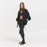 NEOPRENE OUTERWEAR OVERSIZED MOCK NECK JACKET | OBSIDIAN ON A MODEL SIDE VIEW @ | FOCUS: 0.0, 1.0, 0.9