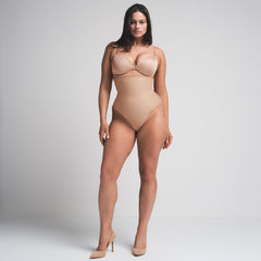 SKIMS BODY CORE SCULPT HIGH-WAISTED THONG | CLAY ON A MODEL FRONT VIEW