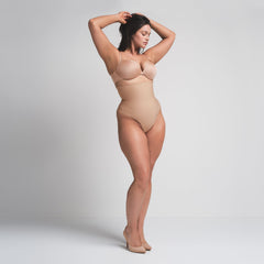 SKIMS BODY CORE SCULPT HIGH-WAISTED THONG | CLAY ON A MODEL FRONT VIEW
