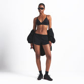NikeSKIMS WOVEN NYLON 2.5" RUNNER SHORT | OBSIDIAN ON A MODEL FRONT VIEW @ | FOCUS: 0.0, 1.0, 0.9