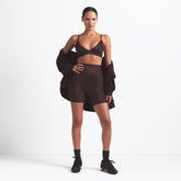 NikeSKIMS SHINE BONDED WAIST 5" BIKER SHORT | PHOENIX ON A MODEL FRONT VIEW @ | FOCUS: 0.9, 0.1, 0.7