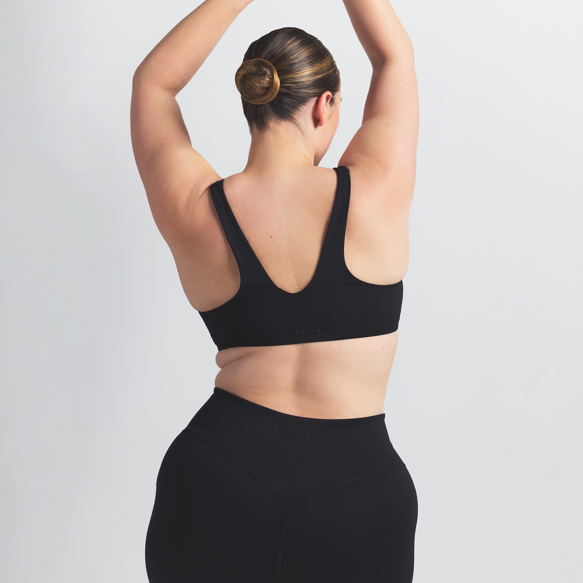 NikeSKIMS MATTE SHAPING SCOOP BRA | OBSIDIAN ON A MODEL BACK VIEW @ | FOCUS: 0.0, 1.0, 0.9