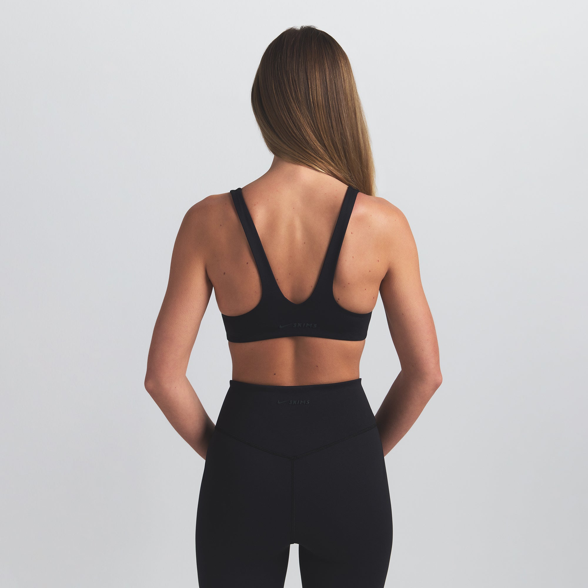 NikeSKIMS MATTE SHAPING SCOOP BRA | OBSIDIAN ON A MODEL BACK VIEW @ | FOCUS: 0.0, 1.0, 0.9