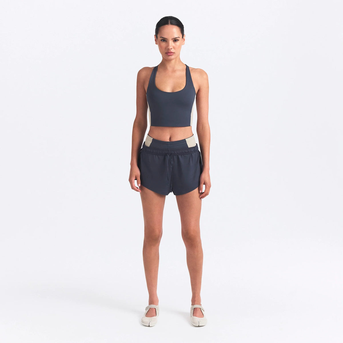 NikeSKIMS MATTE AND SHINE RACERBACK LONGLINE BRA | DEEP ROYAL/STONE ON A MODEL FRONT VIEW @ | FOCUS: 0.0, 1.0, 0.9