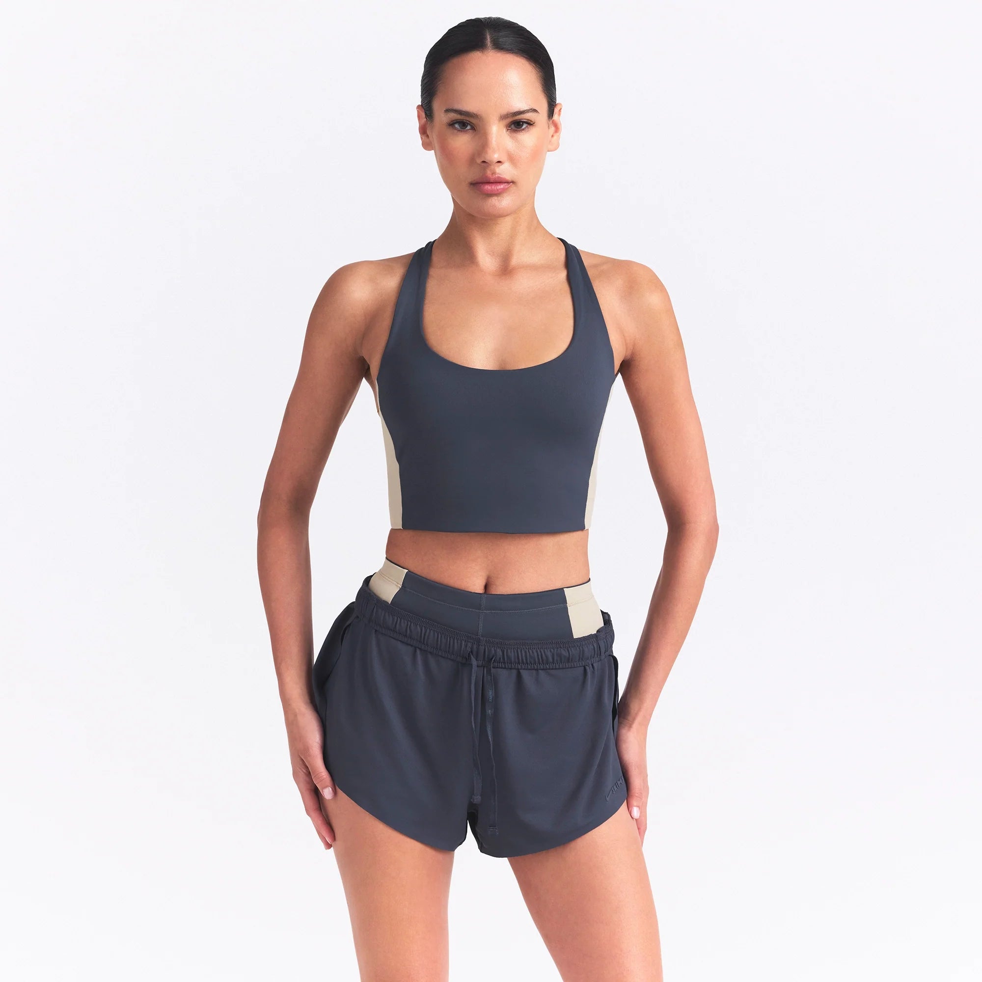 NikeSKIMS MATTE AND SHINE RACERBACK LONGLINE BRA | DEEP ROYAL/STONE ON A MODEL SIDE VIEW @ | FOCUS: 0.0, 1.0, 0.9