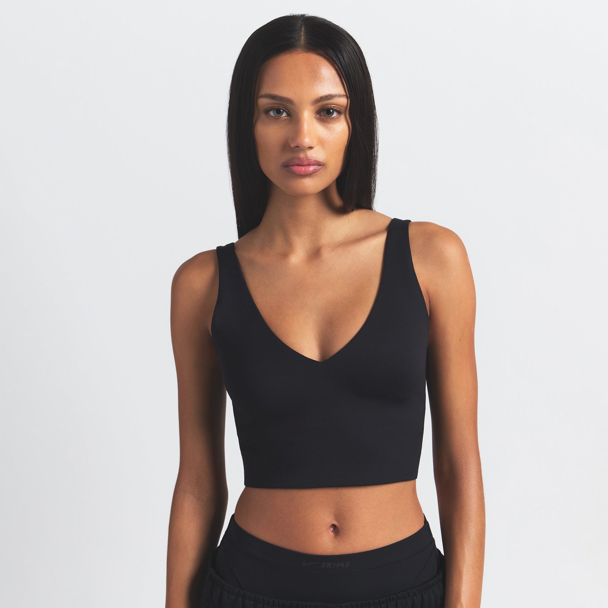 NikeSKIMS MATTE V-NECK BRA TOP | OBSIDIAN ON A MODEL FRONT VIEW