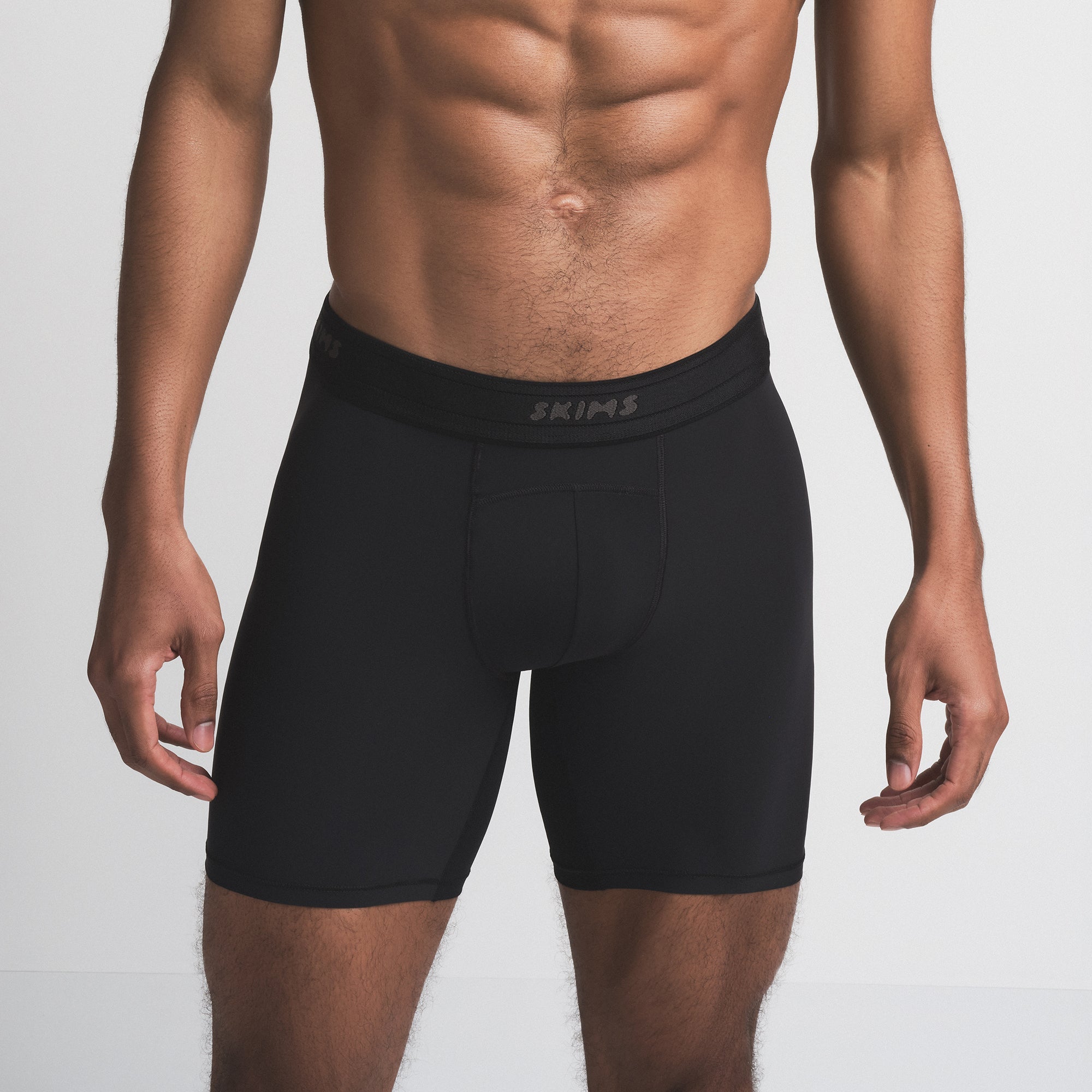 SKIMS SPORT MENS 7" BOXER BRIEF | OBSIDIAN ON A MODEL SIDE VIEW | FOCUS: 0.0, 1.0, 0.9