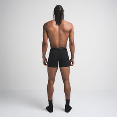 SKIMS SPORT MENS 5" BOXER BRIEF | OBSIDIAN ON A MODEL SIDE VIEW | FOCUS: 0.0, 1.0, 0.9