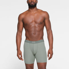 SKIMS COTTON MENS 5" BOXER BRIEF 3-PACK WORN BY A MODEL IN FRONT VIEW