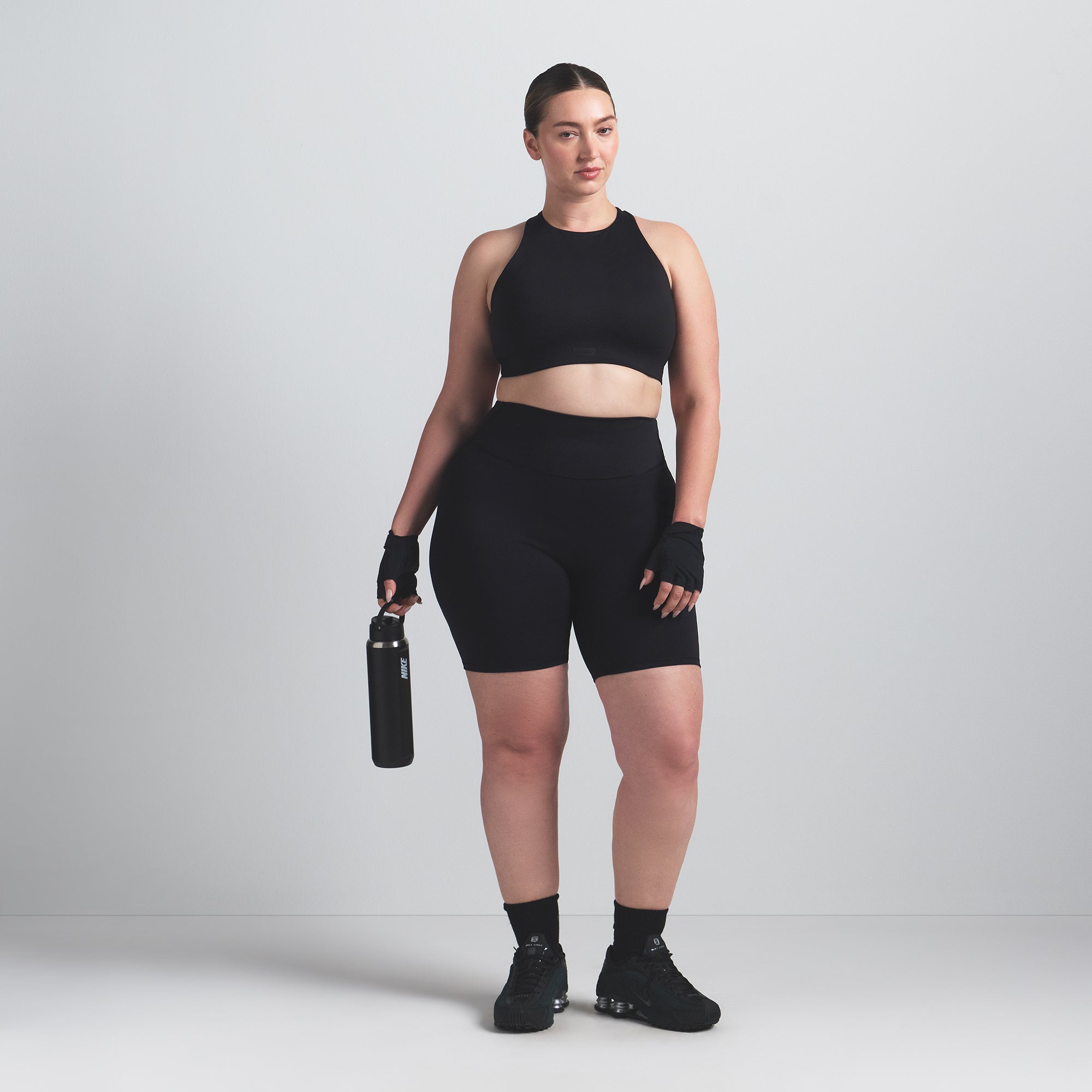 NikeSKIMS MATTE 7" BIKER SHORT | OBSIDIAN ON A MODEL FRONT VIEW