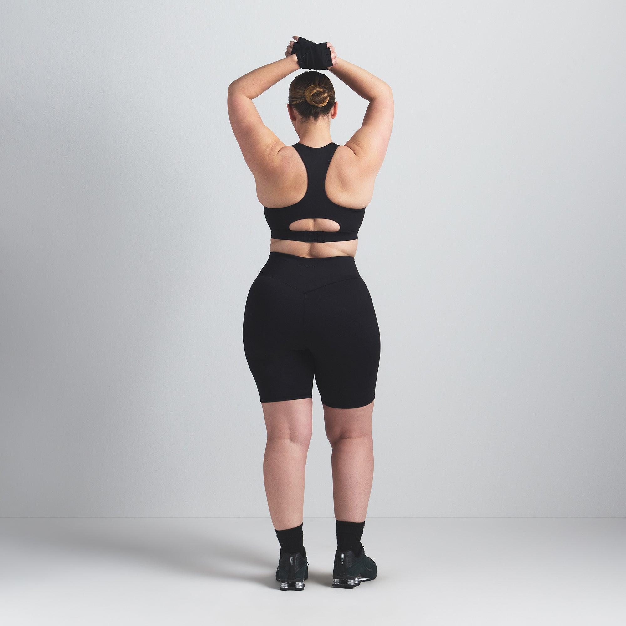 NikeSKIMS MATTE 7" BIKER SHORT | OBSIDIAN ON A MODEL BACK VIEW