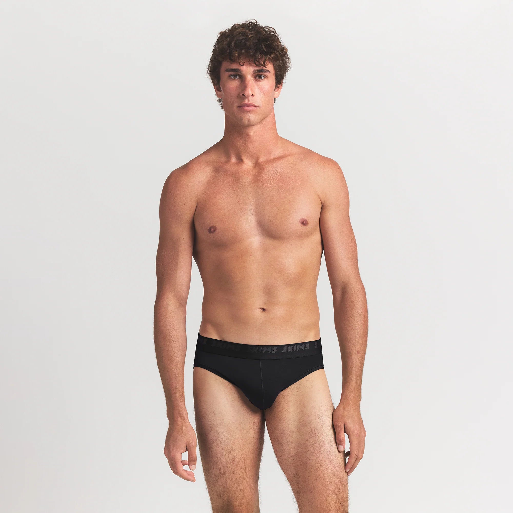 SKIMS STRETCH MENS BRIEF 3-PACK | GUNMETAL MULTI ON A MODEL FRONT VIEW
