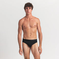 SKIMS STRETCH MENS BRIEF 3-PACK | GUNMETAL MULTI ON A MODEL FRONT VIEW