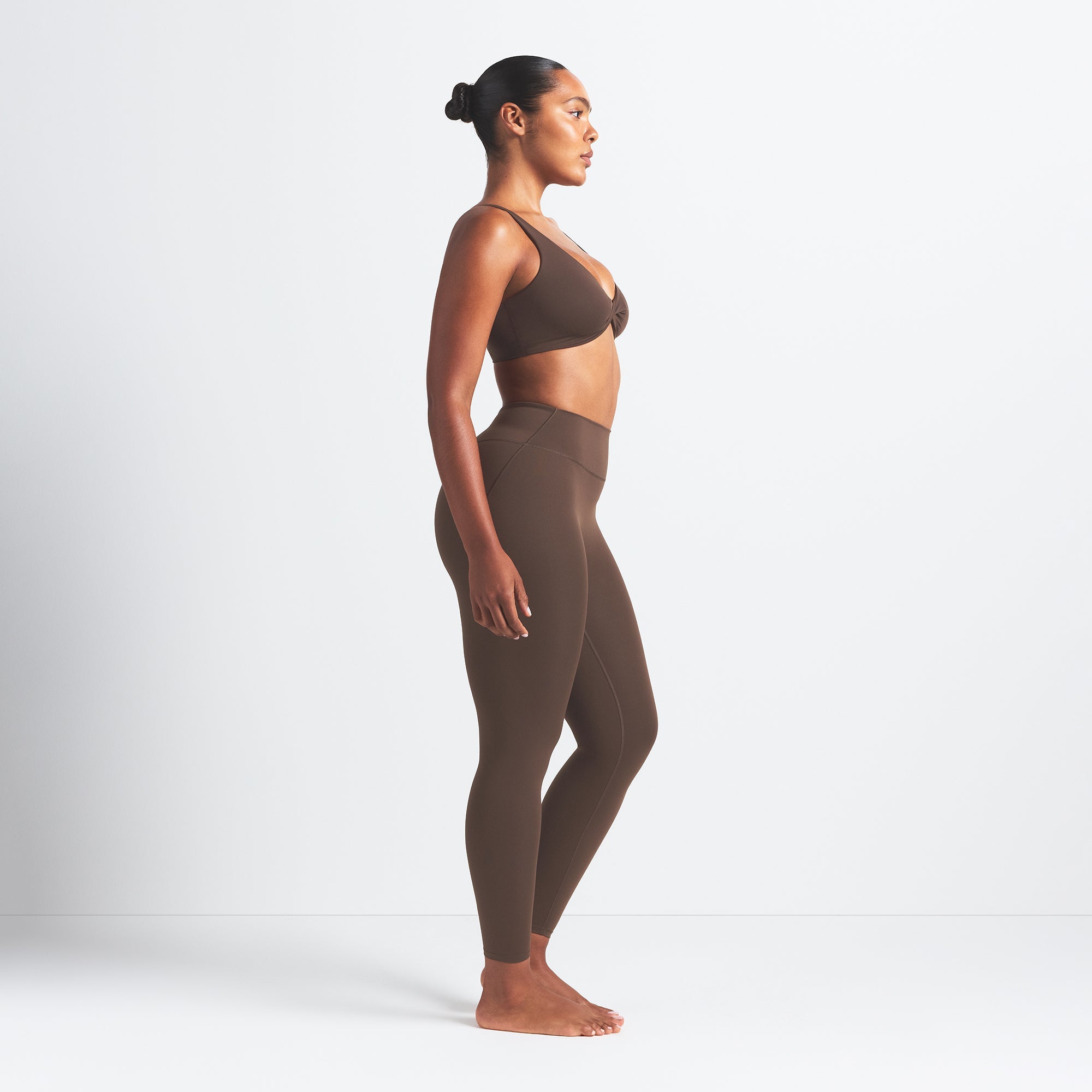 NikeSKIMS MATTE 26" LEGGING | DARK SEPIA ON A MODEL SIDE VIEW