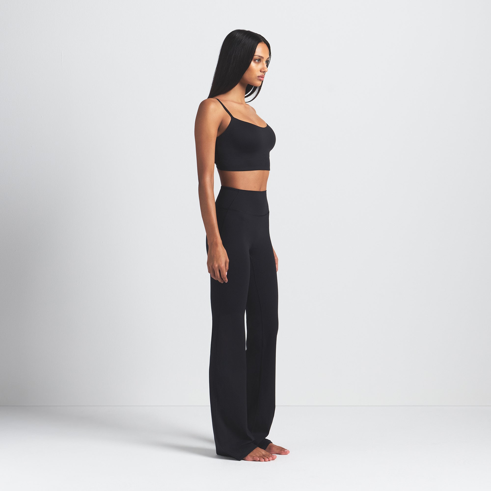 NikeSKIMS MATTE SLIM FLARE LEGGING | OBSIDIAN ON A MODEL SIDE VIEW