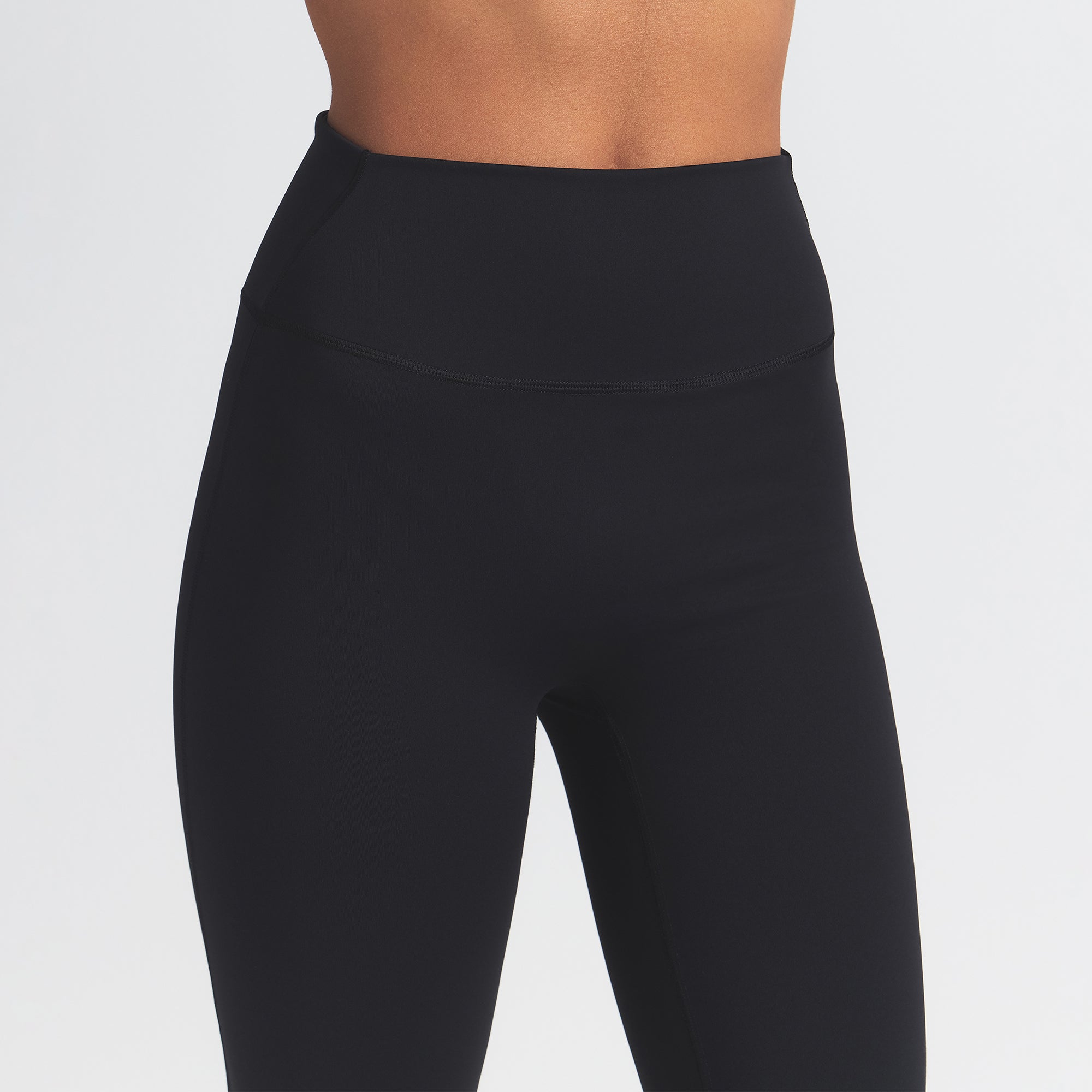 NikeSKIMS MATTE SLIM FLARE LEGGING | OBSIDIAN ON A MODEL FRONT VIEW