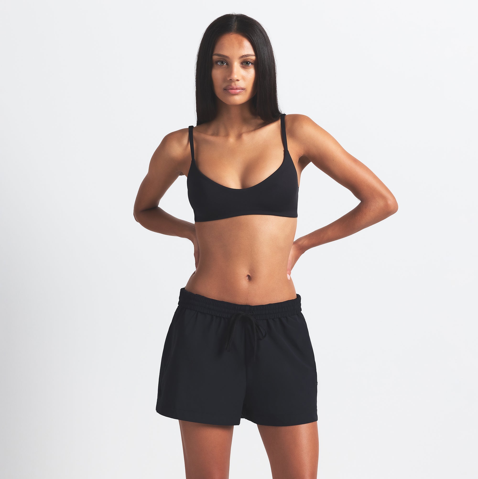 NikeSKIMS WOVEN NYLON 5" TRACK SHORT | OBSIDIAN ON A MODEL FRONT VIEW @ | FOCUS: 0.0, 1.0, 0.9