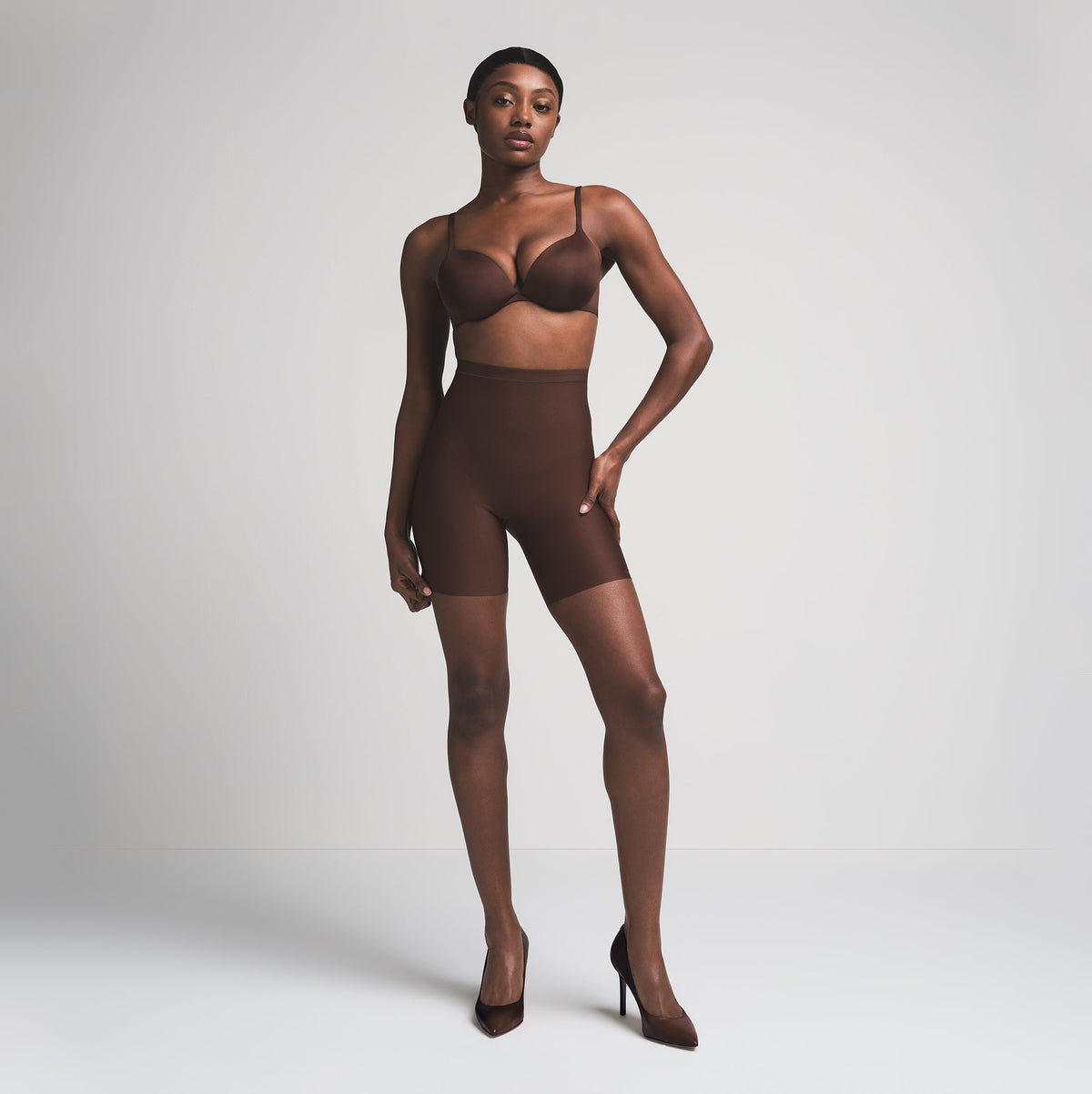 SKIMS BODY CORE SCULPT MID RISE SHORT | COCOA  ON A MODEL FRONT VIEW
