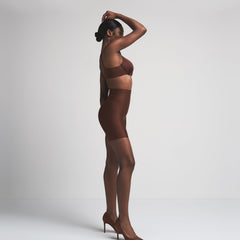 SKIMS BODY CORE SCULPT MID RISE SHORT | COCOA  ON A MODEL SIDE VIEW