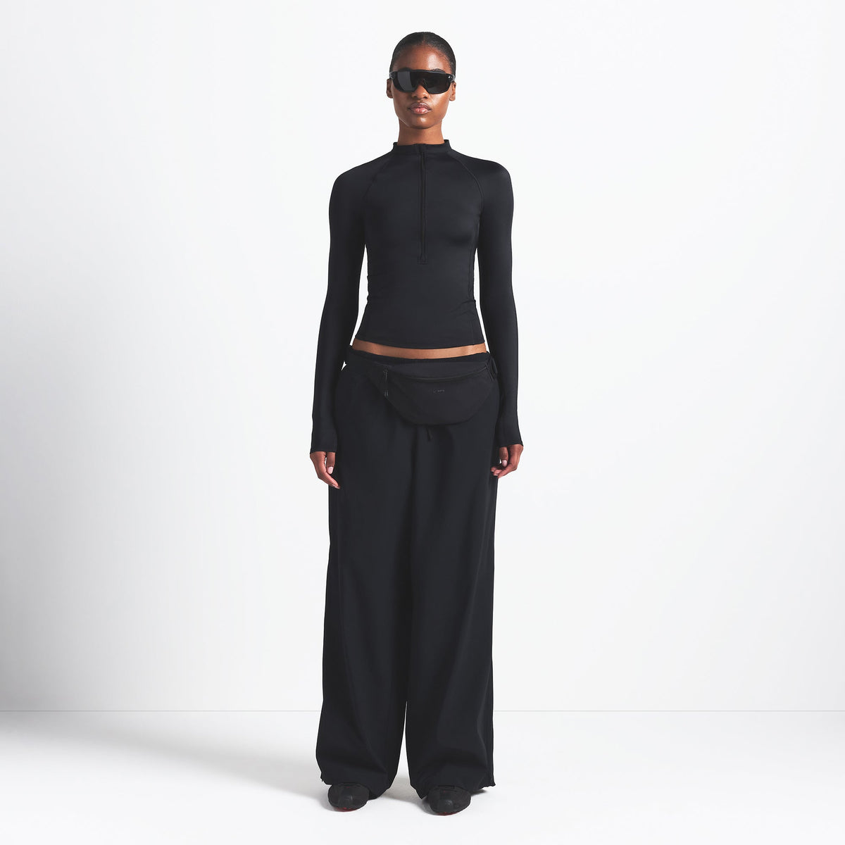 NikeSKIMS WOVEN NYLON OVERSIZED TRACK PANT | OBSIDIAN ON A MODEL FRONT VIEW @ | FOCUS: 0.0, 1.0, 0.9