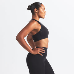 NikeSKIMS MATTE HIGH NECK BRA | OBSIDIAN ON A MODEL SIDE VIEW