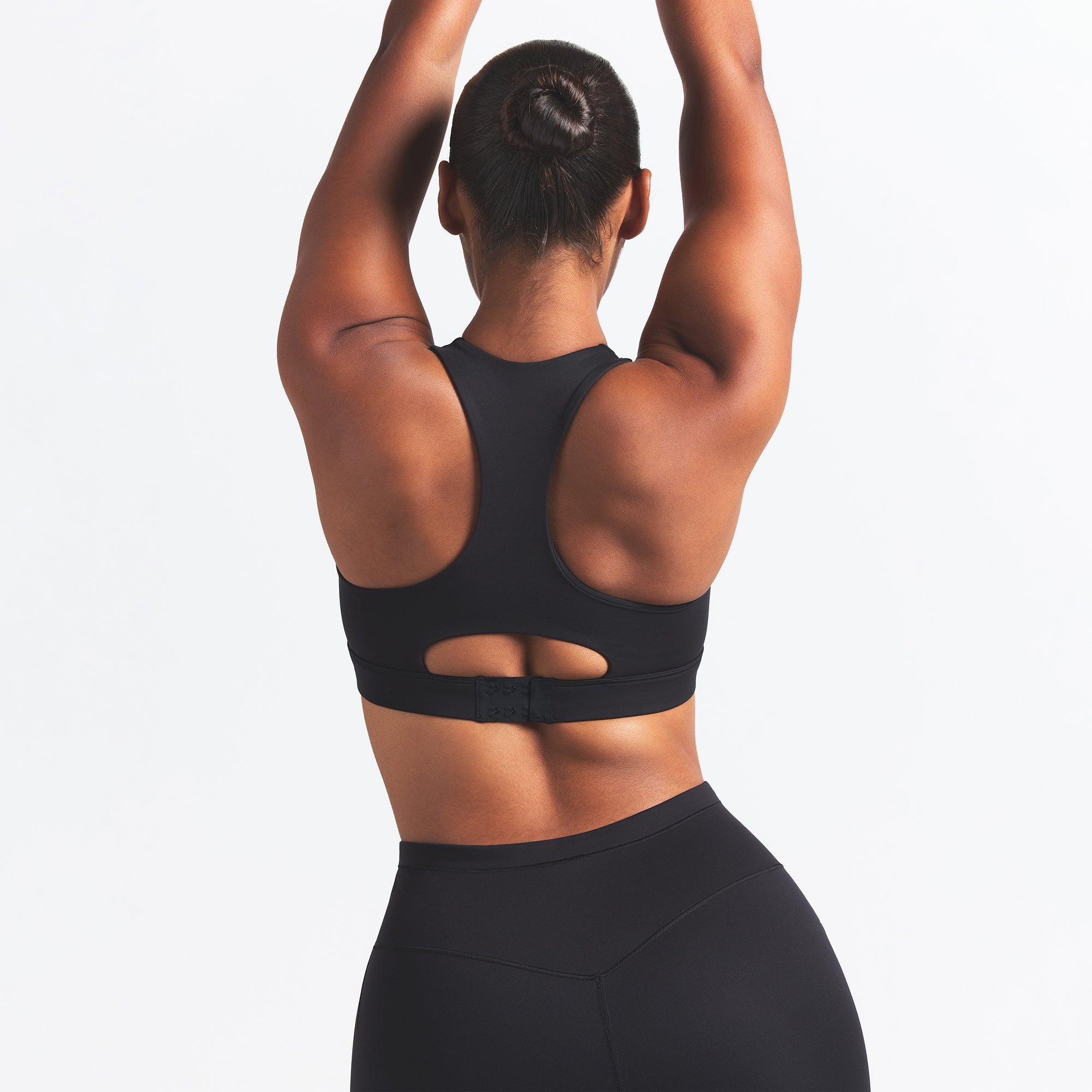 NikeSKIMS MATTE HIGH NECK BRA | OBSIDIAN ON A MODEL BACK VIEW