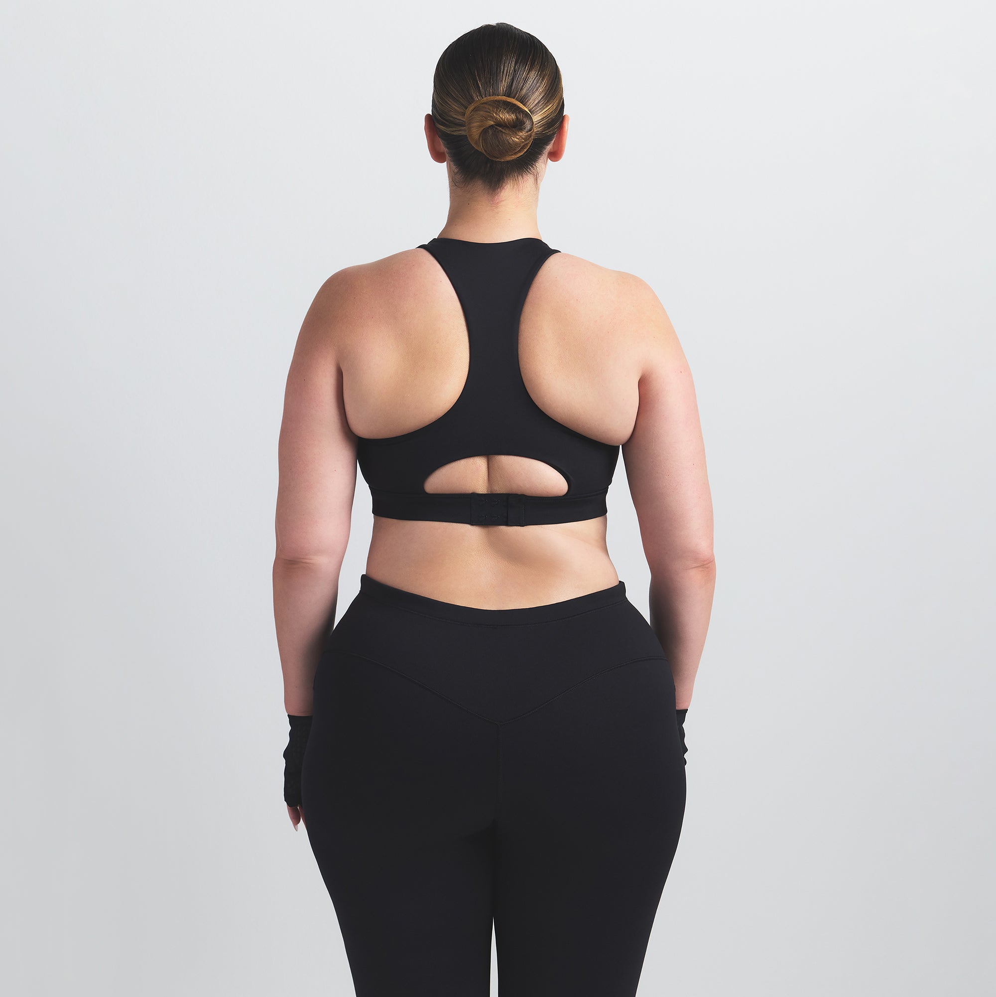 NikeSKIMS MATTE HIGH NECK BRA | OBSIDIAN ON A MODEL BACK VIEW