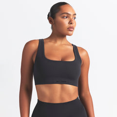 NikeSKIMS VINTAGE SEAMLESS SCOOP NECK BRA | OBSIDIAN ON A MODEL SIDE VIEW @ | FOCUS: 0.9, 0.1, 0.7