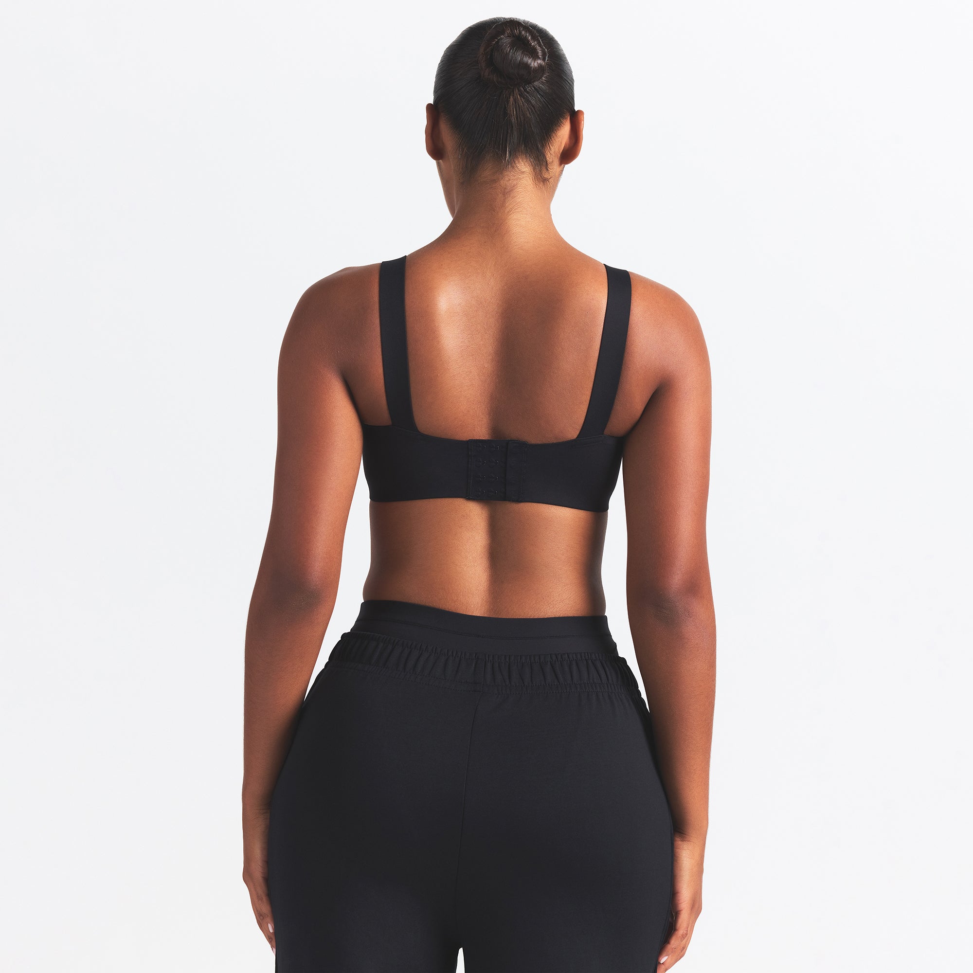 NikeSKIMS MATTE WIDE STRAP BRA | OBSIDIAN ON A MODEL BACK VIEW