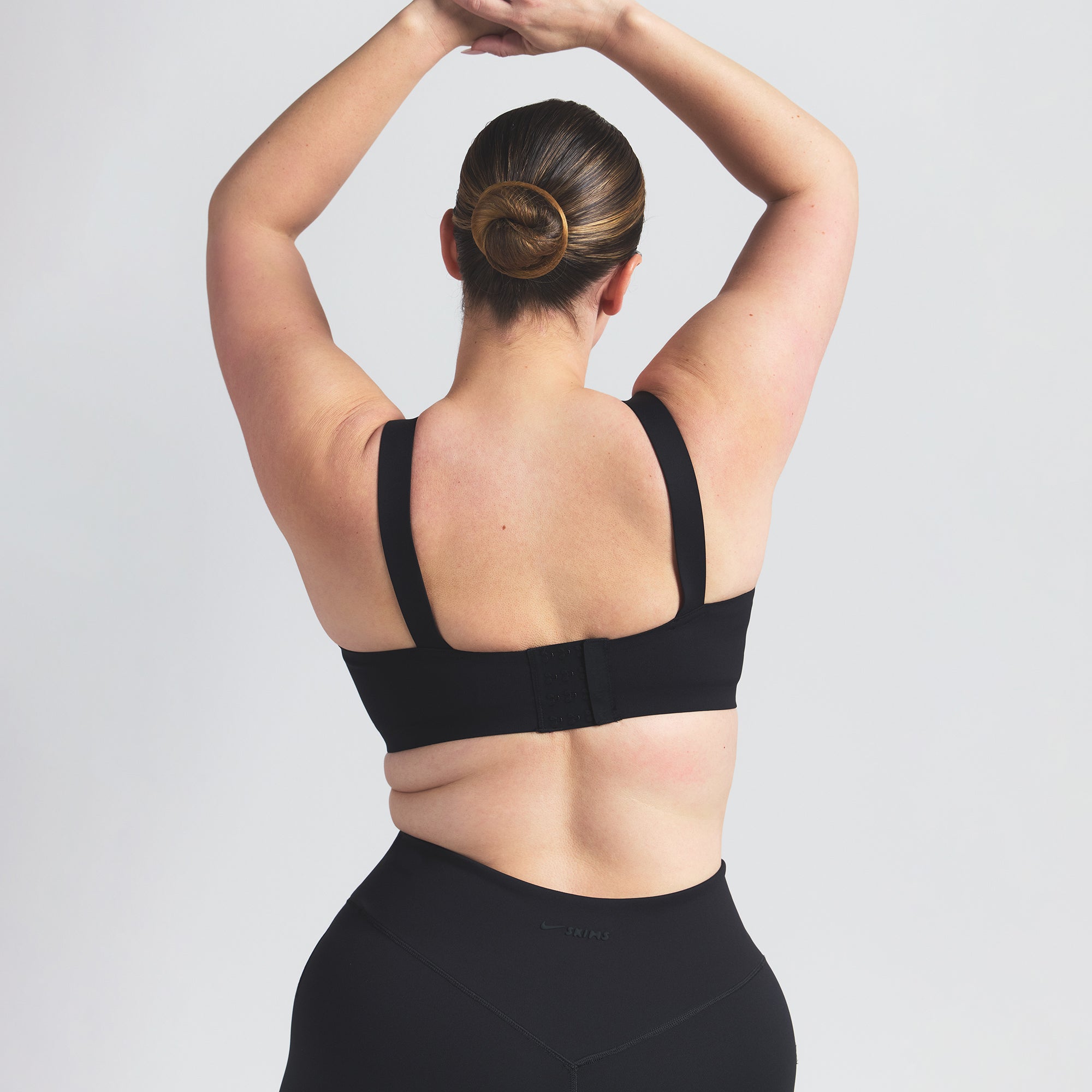 NikeSKIMS MATTE WIDE STRAP BRA | OBSIDIAN ON A MODEL BACK VIEW