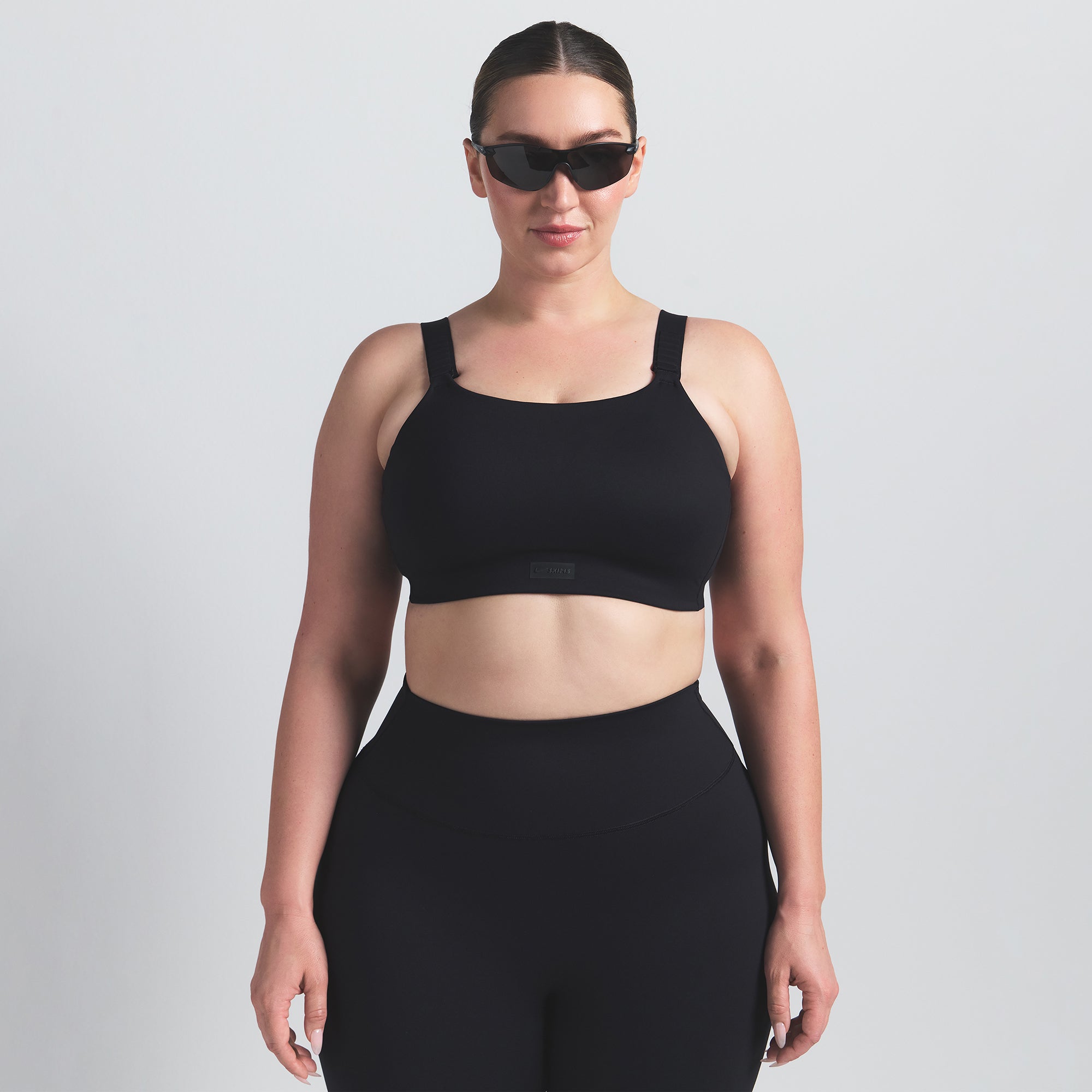 NikeSKIMS MATTE WIDE STRAP BRA | OBSIDIAN ON A MODEL FRONT VIEW
