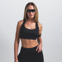 NikeSKIMS SHINE RACER BACK BRA | OBSIDIAN ON A MODEL SIDE VIEW @ | FOCUS: 0.9, 0.1, 0.7